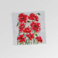 A greeting card with a floral design featuring red poppies and green leaves on a white background.