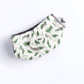 A bowl cozy with a floral pattern, primarily in green and white colors, designed to be worn on a finger for holding a hot bowl.